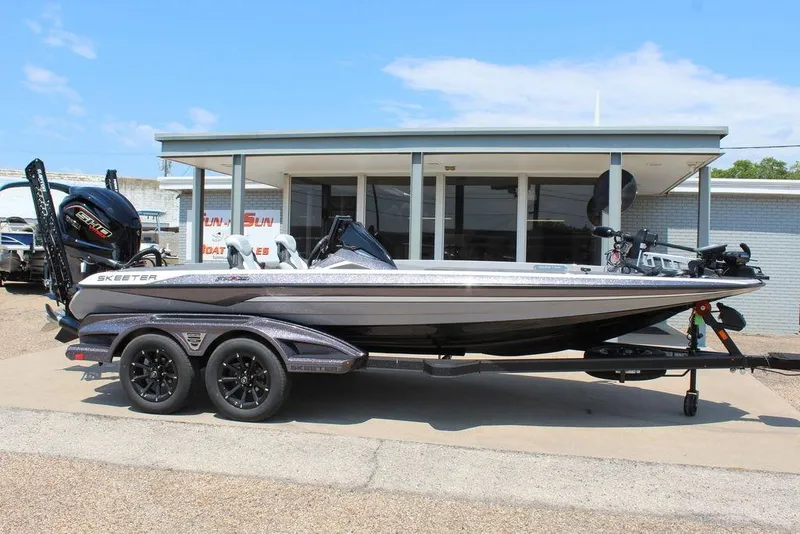 Slide: The Image of 2026 Skeeter FXR20 FLEX boat on trailer outside dealership. - 4