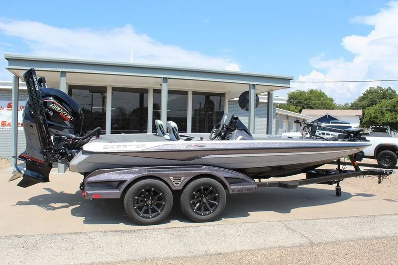 Slide: The Image of 2026 Skeeter FXR20 FLEX boat on trailer outside dealership, side view. - 7