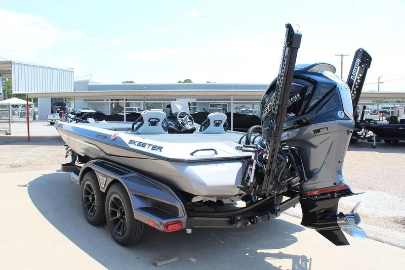 Slide: The Image of 2026 Skeeter FXR20 FLEX boat with dual motors and sleek design on a trailer. - 8