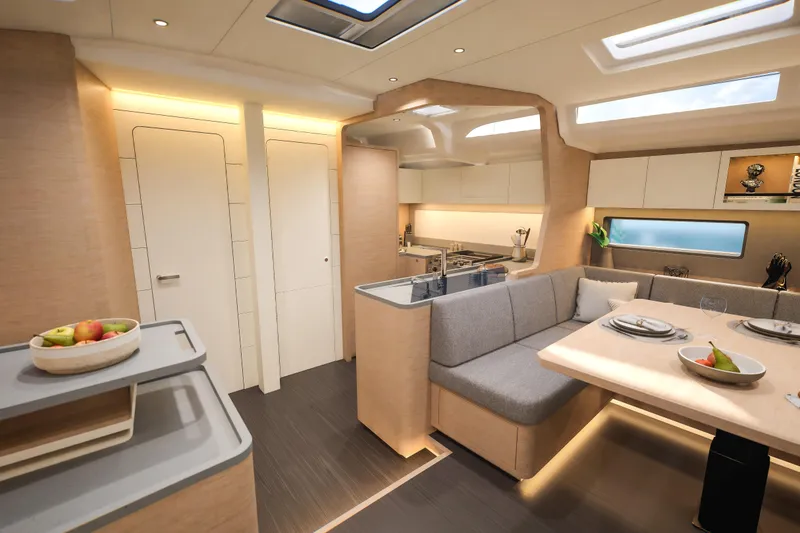 Slide: The Image of Luxurious interior of 2026 Dufour 54 yacht with modern kitchen and dining area. - 25