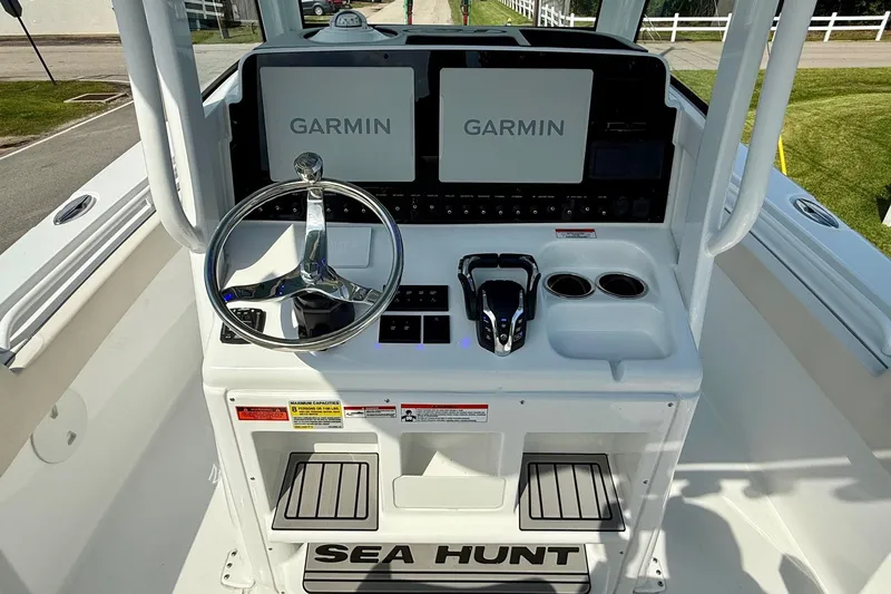 Slide: The Image of 2026 Sea Hunt Gamefish 25 helm with dual Garmin displays and modern controls. - 11