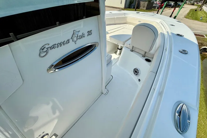 Slide: The Image of 2026 Sea Hunt Gamefish 25 boat interior, featuring sleek white design and comfortable seating. - 17