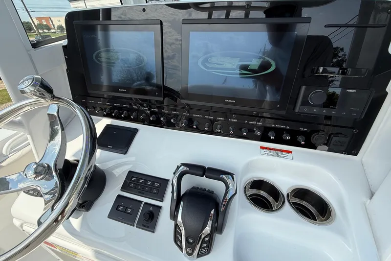 Slide: The Image of 2026 Sea Hunt Gamefish 25 dashboard with dual Garmin displays and modern controls. - 19