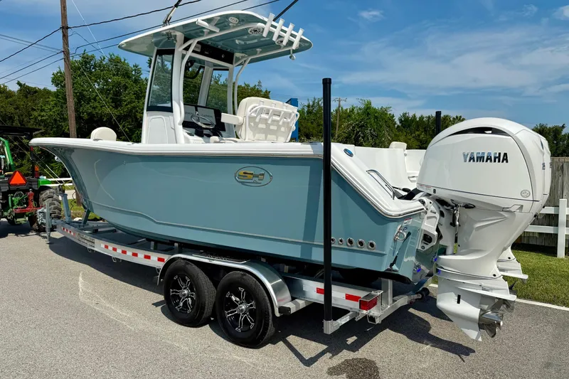 Slide: The Image of 2026 Sea Hunt Gamefish 25 boat on trailer with Yamaha outboard motor. - 2