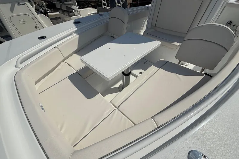Slide: The Image of 2026 Sea Hunt Gamefish 25 boat interior with cushioned seating and table. - 22