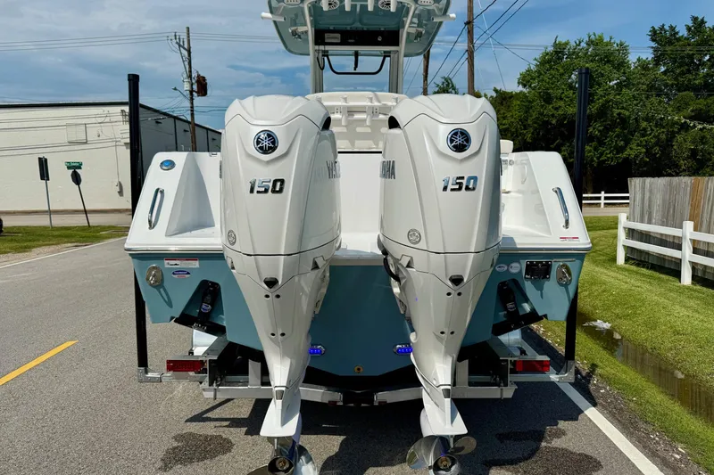 Slide: The Image of 2026 Sea Hunt Gamefish 25 with dual Yamaha 150 engines on a sunny street. - 3