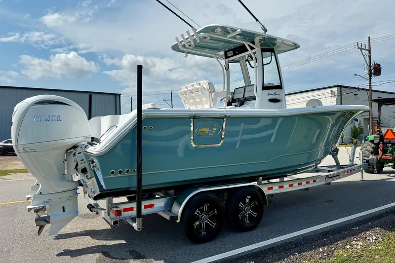 Slide: The Image of 2026 Sea Hunt Gamefish 25 boat on trailer, featuring Yamaha outboard motor. - 4