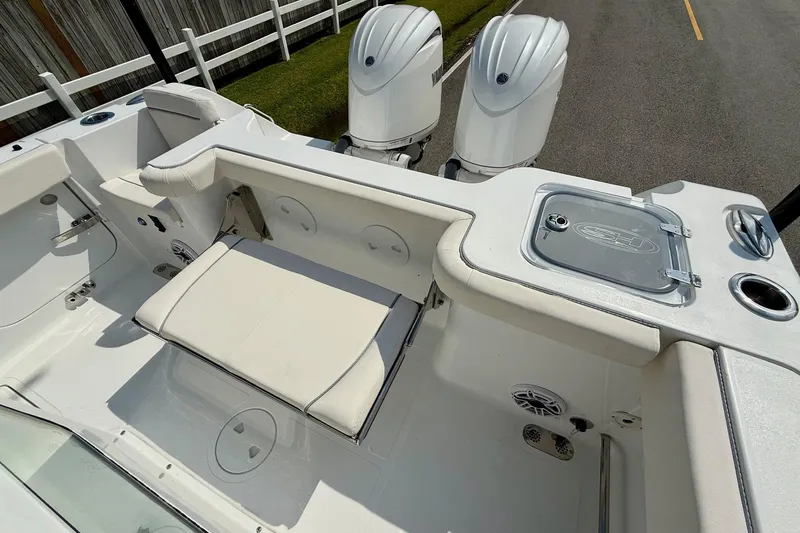 Slide: The Image of 2026 Sea Hunt Gamefish 25 boat interior with dual engines and seating area. - 7