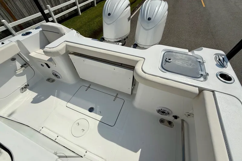 Slide: The Image of 2026 Sea Hunt Gamefish 25 boat interior with dual engines and seating area. - 8