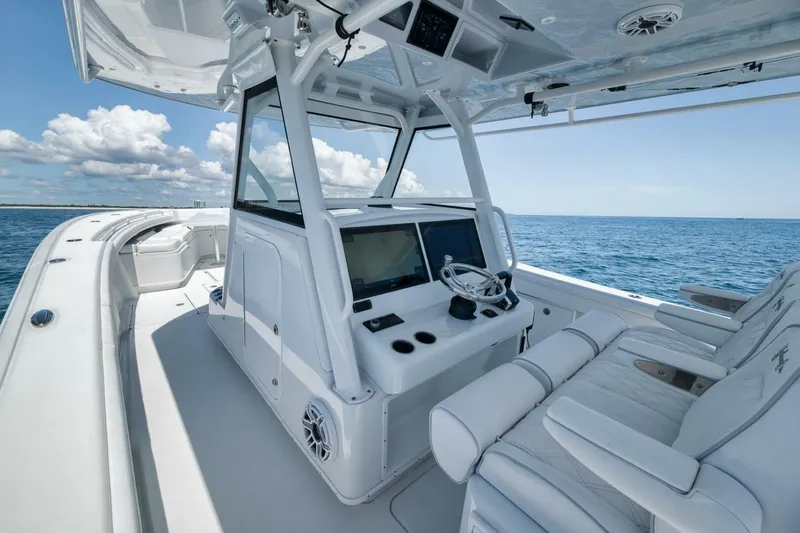 Slide: The Image of 2023 Yellowfin 39 Offshore boat interior with helm, ocean view, and clear sky. - 12