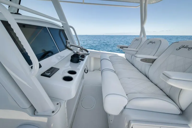 Slide: The Image of 2023 Yellowfin 39 Offshore boat interior with luxurious seating and ocean view. - 15
