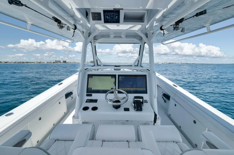 Slide: The Image of 2023 Yellowfin 39 Offshore boat interior with advanced navigation system on open sea. - 16