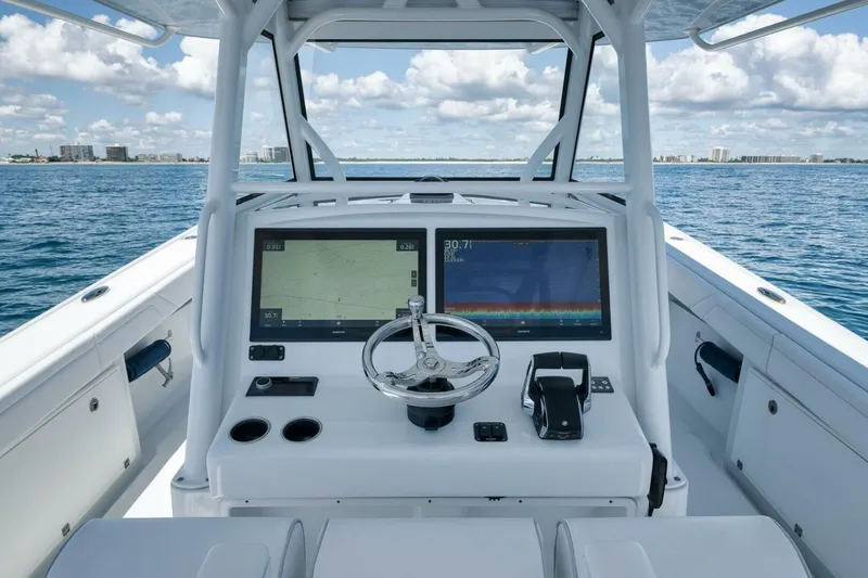 Slide: The Image of 2023 Yellowfin 39 Offshore boat helm with dual screens and ocean view. - 17