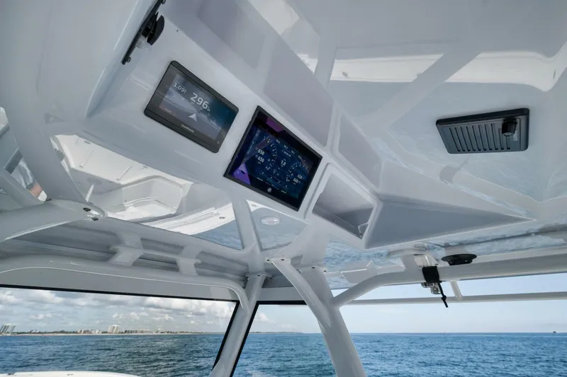 Slide: The Image of 2023 Yellowfin 39 Offshore boat interior with navigation screens, ocean view. - 18