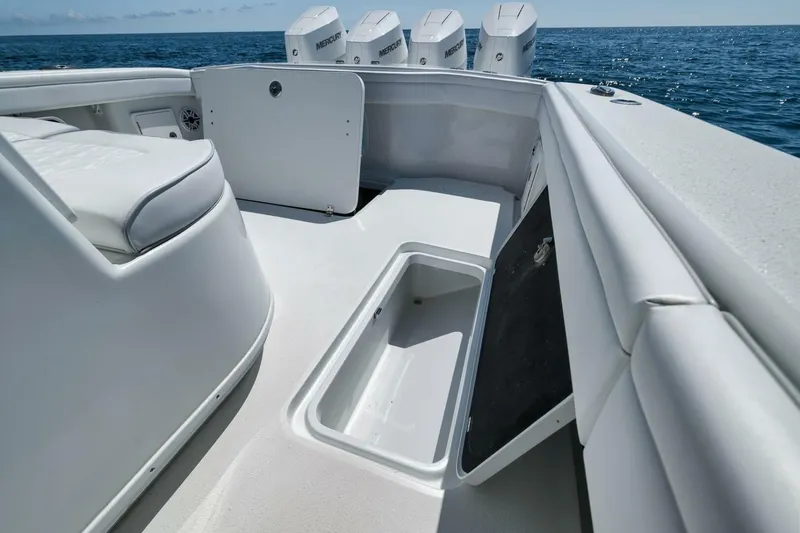Slide: The Image of 2023 Yellowfin 39 Offshore boat interior with storage compartment and Mercury engines. - 20