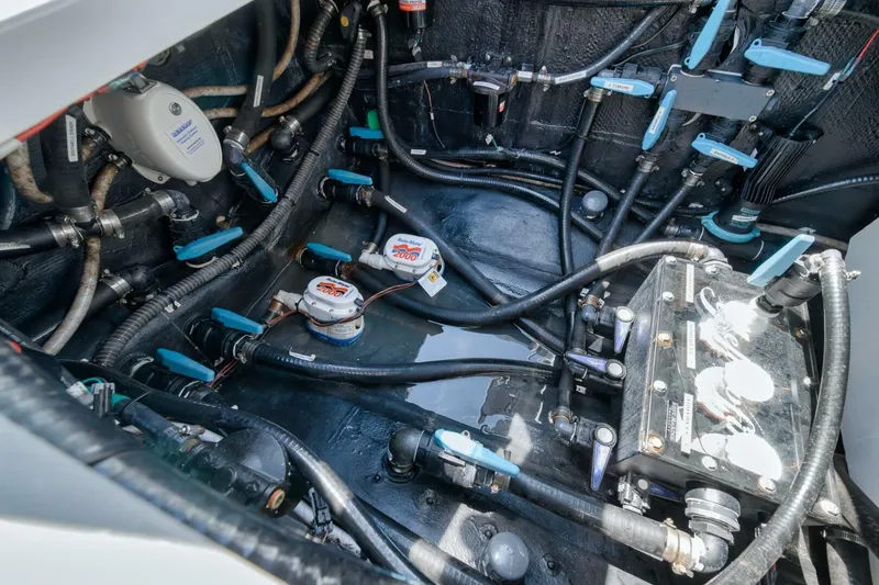 Slide: The Image of Engine compartment of 2023 Yellowfin 39 Offshore boat, showcasing intricate wiring and components. - 23