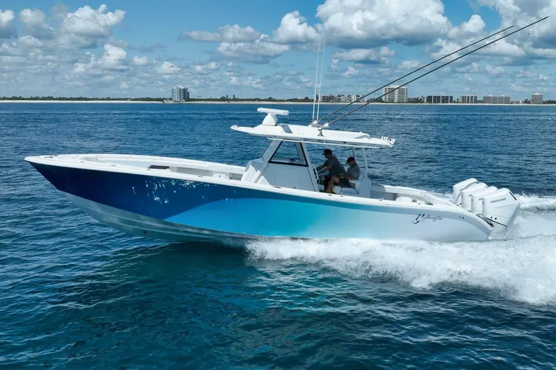 Slide: The Image of 2023 Yellowfin 39 Offshore boat cruising on open water under a blue sky. - 3