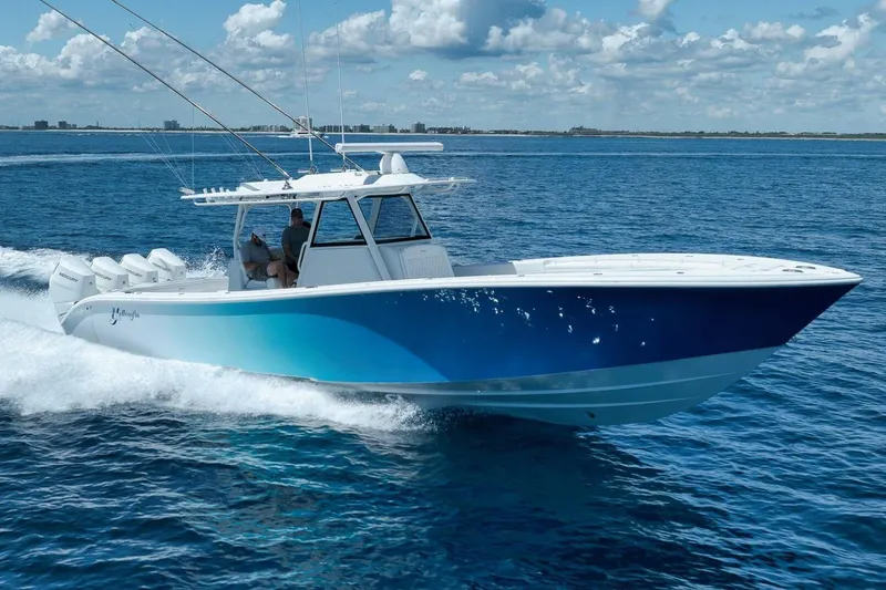 Slide: The Image of 2023 Yellowfin 39 Offshore boat cruising on open water under a clear sky. - 32