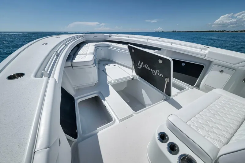 Slide: The Image of 2023 Yellowfin 39 Offshore boat interior with seating and storage, on open water. - 9