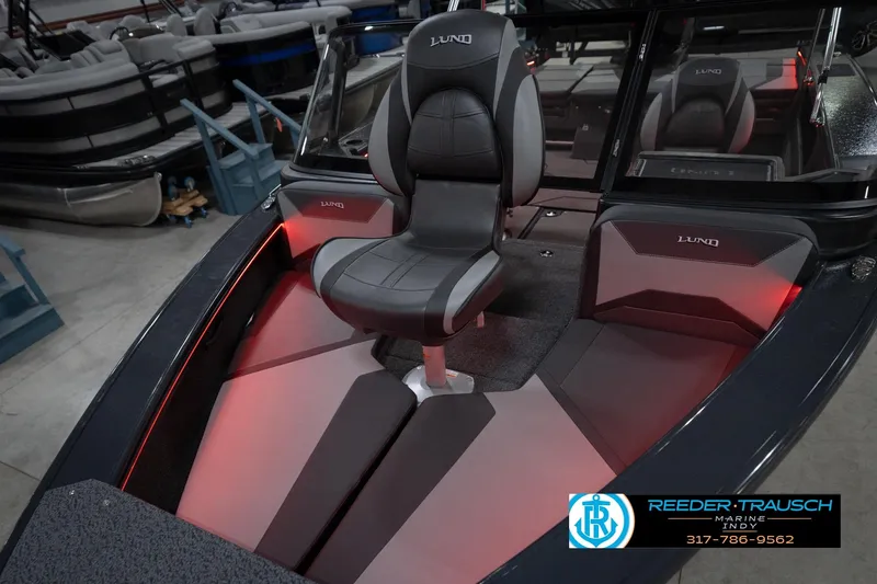 Slide: The Image of 2026 Lund 1875 Crossover XS boat interior with sleek seating and ambient lighting. - 11