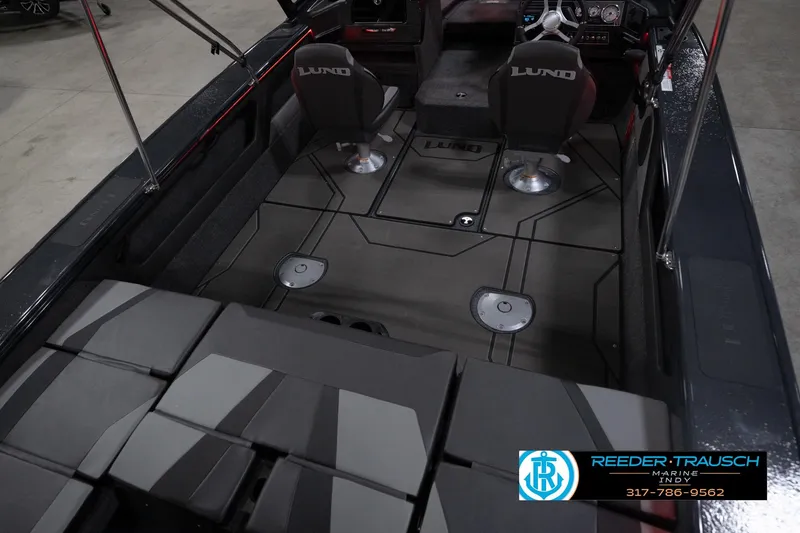 Slide: The Image of 2026 Lund 1875 Crossover XS boat interior with seating and steering console. - 13