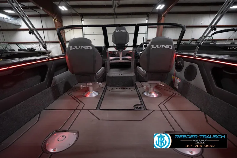 Slide: The Image of 2026 Lund 1875 Crossover XS boat interior with seating and red accent lighting. - 15