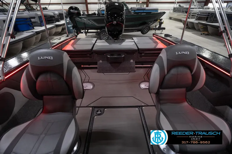 Slide: The Image of 2026 Lund 1875 Crossover XS boat interior with seating and red accent lighting. - 19