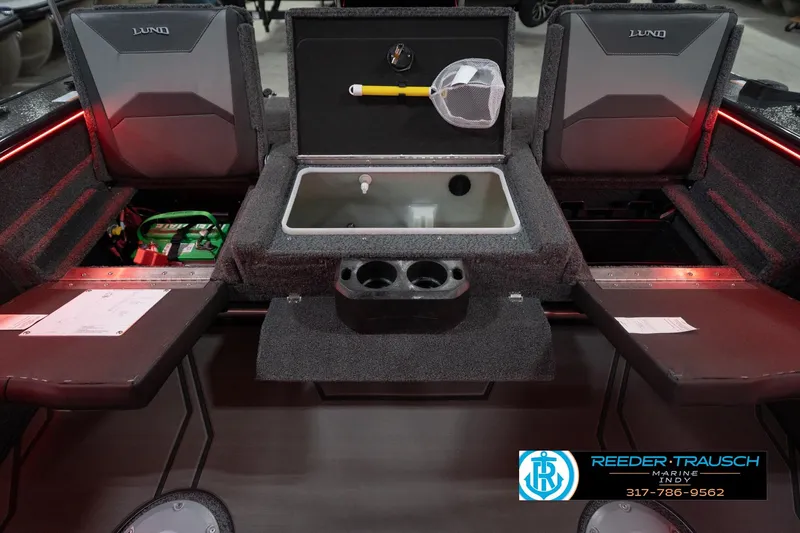 Slide: The Image of 2026 Lund 1875 Crossover XS boat interior with storage compartments and fishing gear. - 22