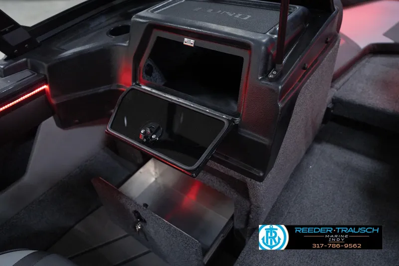 Slide: The Image of 2026 Lund 1875 Crossover XS interior storage compartments with red accent lighting. - 24