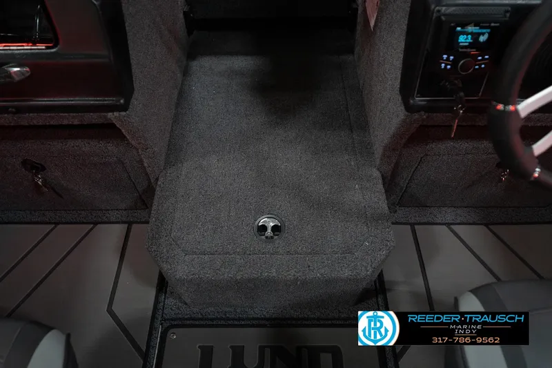 Slide: The Image of Interior of 2026 Lund 1875 Crossover XS boat with carpeted flooring and steering wheel. - 25
