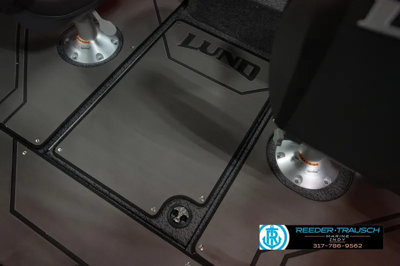 Slide: The Image of 2026 Lund 1875 Crossover XS boat interior with branded flooring and seat bases. - 27