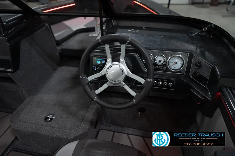 Slide: The Image of 2026 Lund 1875 Crossover XS boat dashboard with steering wheel and gauges. - 33