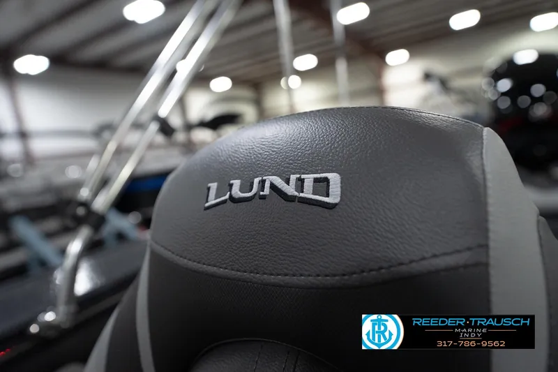 Slide: The Image of 2026 Lund 1875 Crossover XS boat seat with logo in showroom setting. - 44