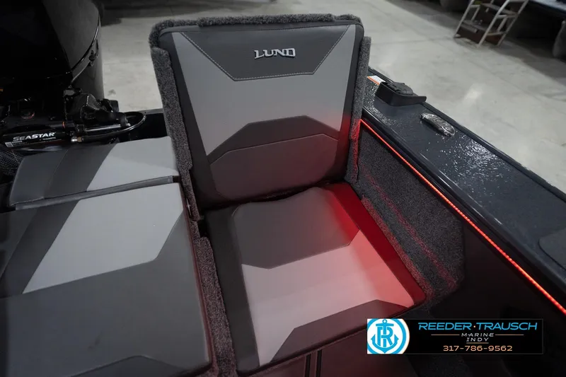 Slide: The Image of 2026 Lund 1875 Crossover XS boat seat with red accent lighting, Reeder-Trausch Marine logo. - 46