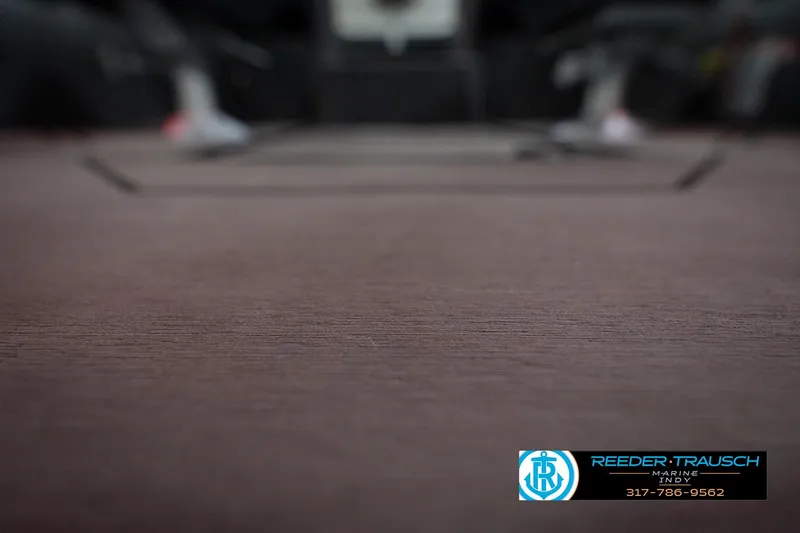 Slide: The Image of Blurred interior view of a 2026 Lund 1875 Crossover XS boat, featuring Reeder-Trausch Marine logo. - 48