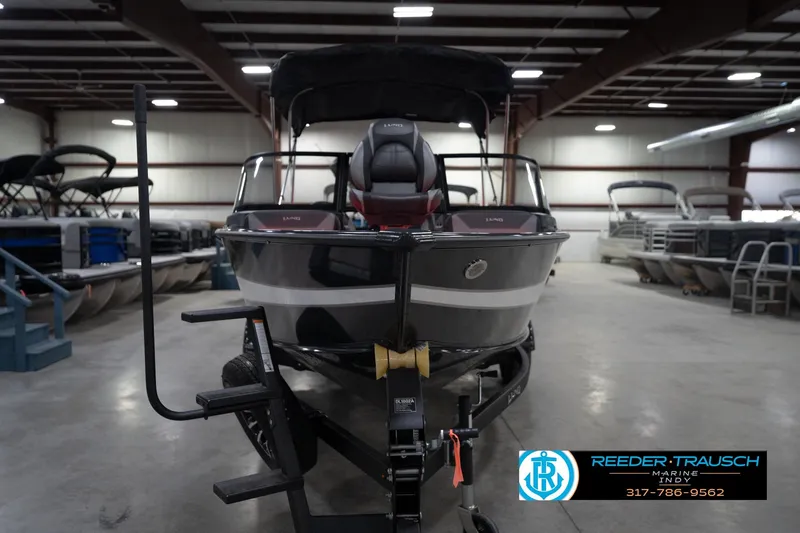 Slide: The Image of 2026 Lund 1875 Crossover XS boat in showroom, front view, Reeder Trausch Marine. - 5