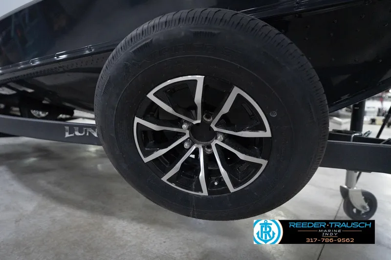 Slide: The Image of 2026 Lund 1875 Crossover XS trailer wheel with sleek black and silver design. - 59