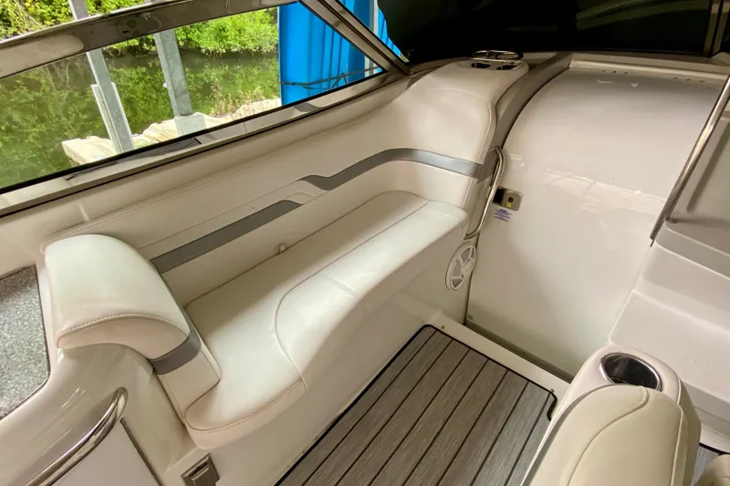 Slide: The Image of 2005 Formula 330 Sun Sport boat interior with white seating and wood flooring. - 10