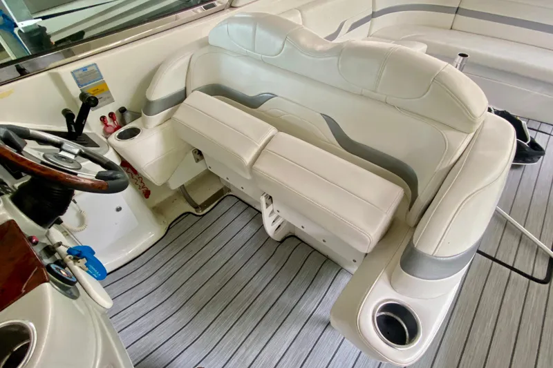 Slide: The Image of 2005 Formula 330 Sun Sport boat interior with white leather seating and steering wheel. - 11
