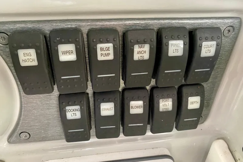 Slide: The Image of Control panel of a 2005 Formula 330 Sun Sport boat with labeled switches. - 15