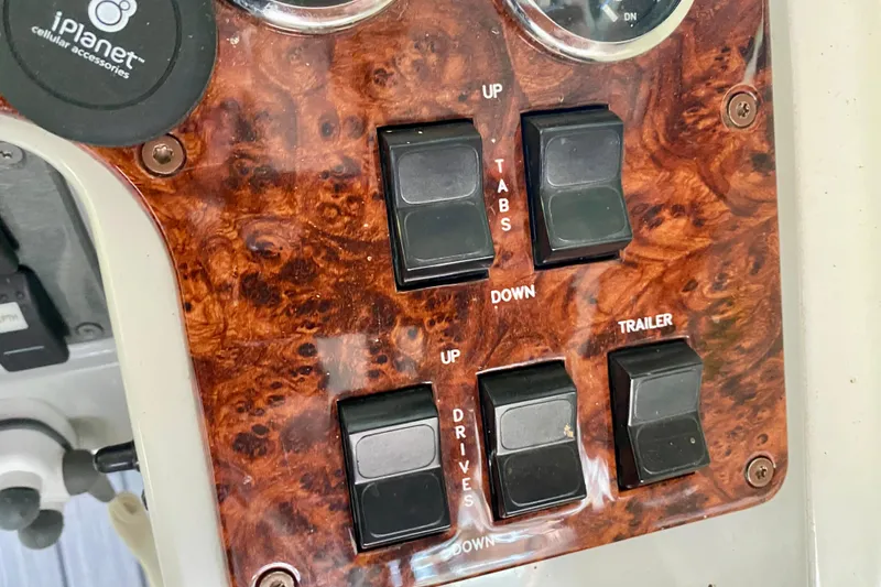 Slide: The Image of Control panel of a 2005 Formula 330 Sun Sport boat with wood finish and switches. - 17