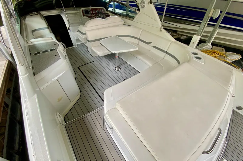 Slide: The Image of 2005 Formula 330 Sun Sport boat interior with seating and table, featuring sleek design. - 19