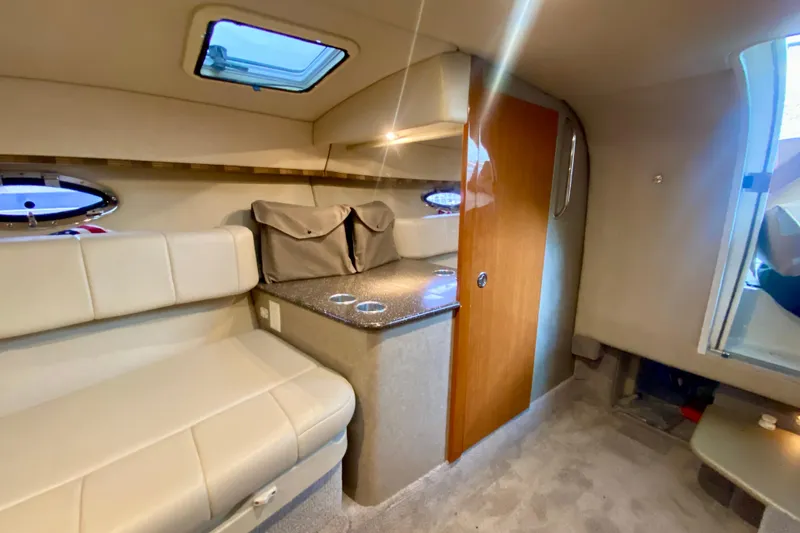 Slide: The Image of 2005 Formula 330 Sun Sport cabin interior with seating, countertop, and wooden door. - 22