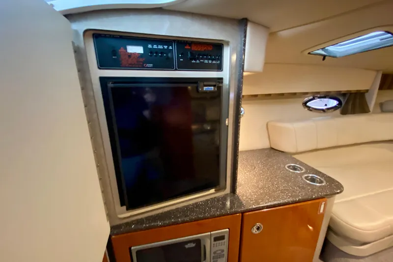 Slide: The Image of Interior of 2005 Formula 330 Sun Sport boat with kitchenette and seating area. - 24