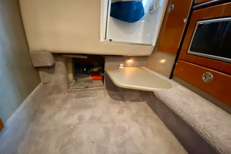 Slide: The Image of Interior cabin of 2005 Formula 330 Sun Sport boat, featuring storage and carpeted flooring. - 27