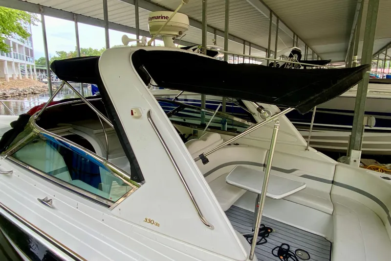 Slide: The Image of 2005 Formula 330 Sun Sport boat docked under a covered marina. - 3
