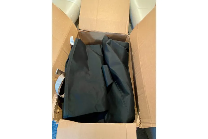 Slide: The Image of Open cardboard box with black fabric inside, related to 2005 Formula 330 Sun Sport. - 32