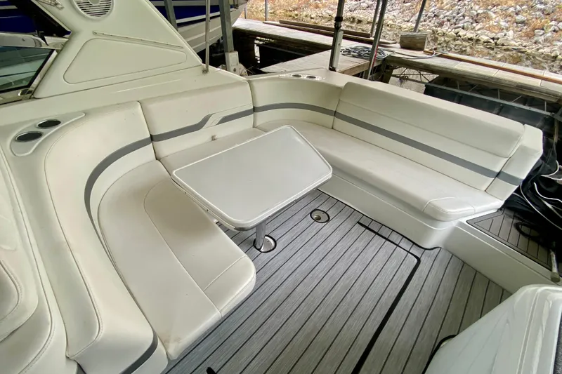 Slide: The Image of 2005 Formula 330 Sun Sport boat interior with white seating and table. - 6