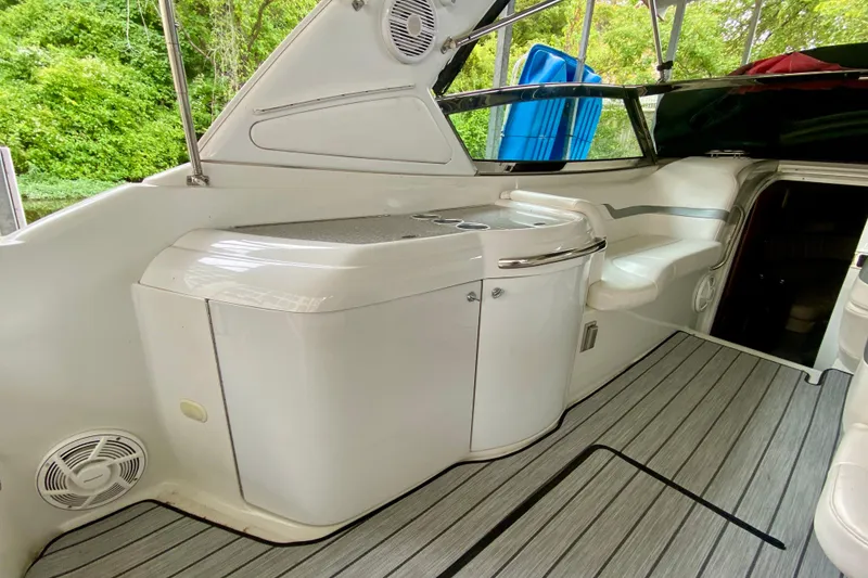 Slide: The Image of 2005 Formula 330 Sun Sport boat interior with sleek white cabinetry and seating. - 7