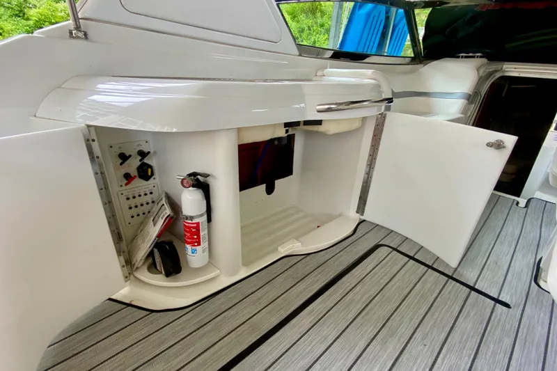 Slide: The Image of 2005 Formula 330 Sun Sport interior with open storage, fire extinguisher, and control panel. - 8